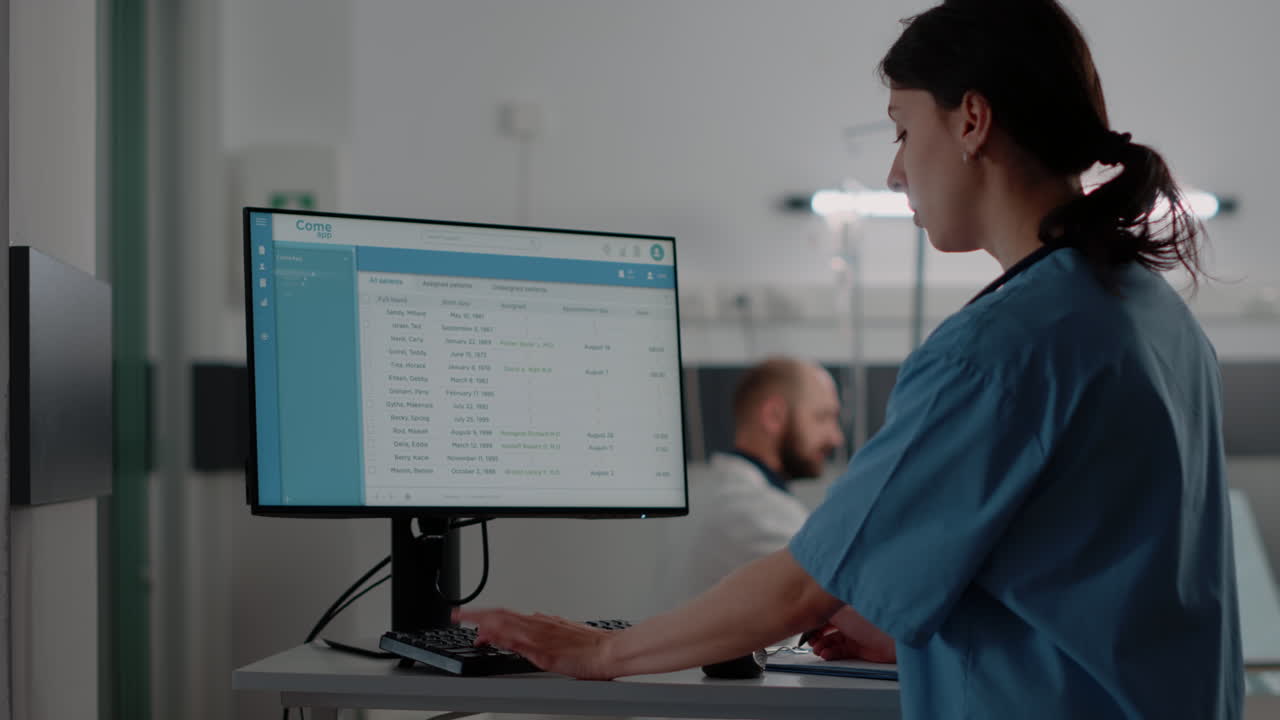 Close up of woman nurse working on computer in hospital ward