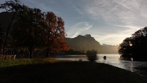 stunning autumn sunset over swiss lake and mountains