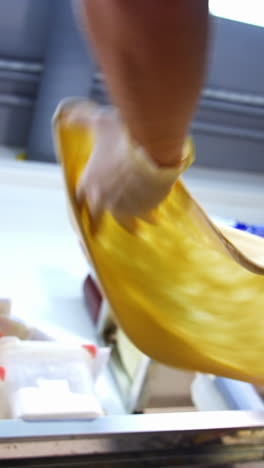 process of making pizza dough. professional chef spinning dough for pizza and tossing up in the kitchen. vertical video
