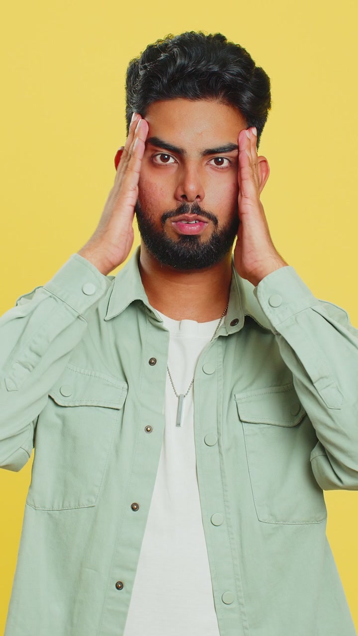 Scared fearful depressed indian man suffering phobia anxiety disorder expresses fear stress panic