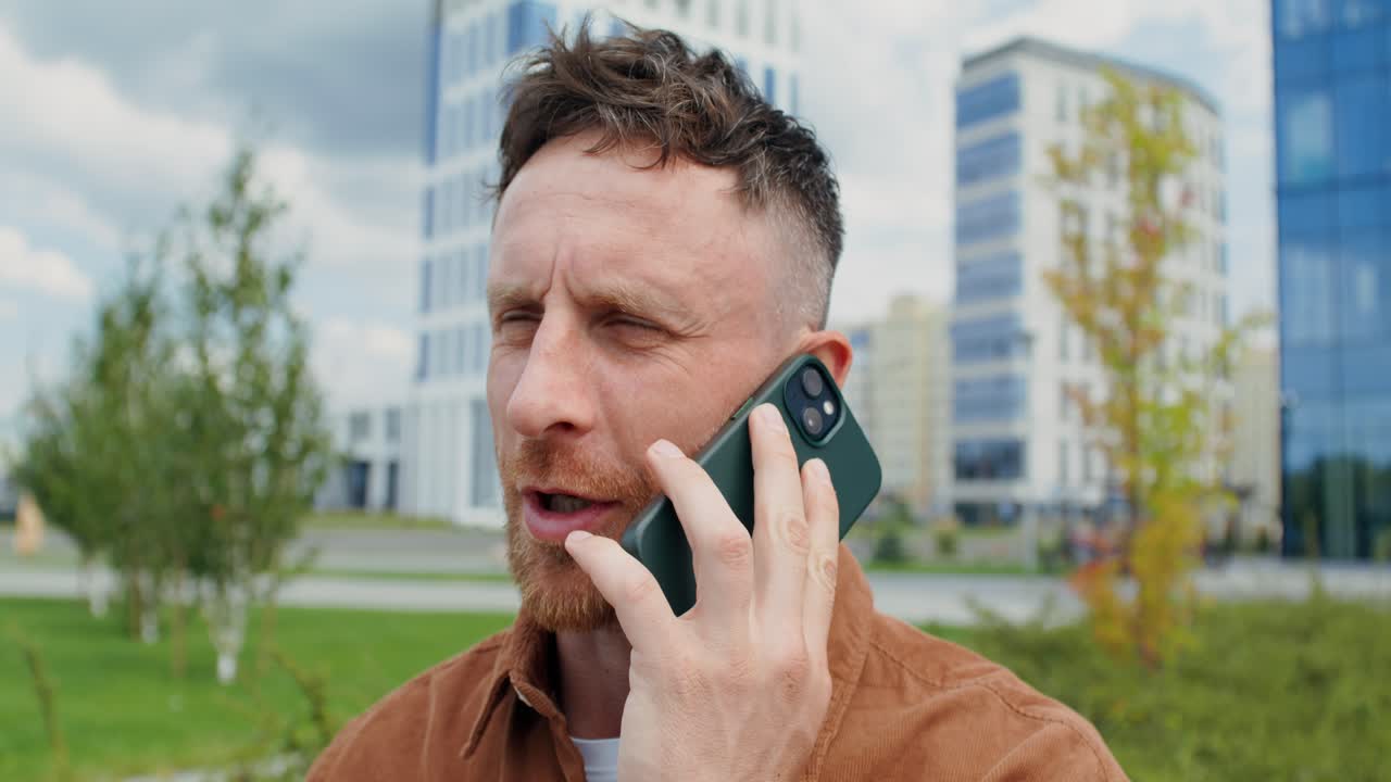 Man Talking on Phone in Urban Setting