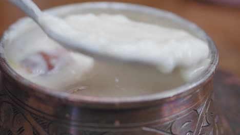 a close up of a turkish creamy soup with bread croutons