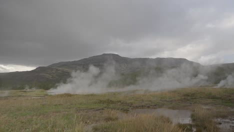 steaming geothermal fields beneath icelandic mountains