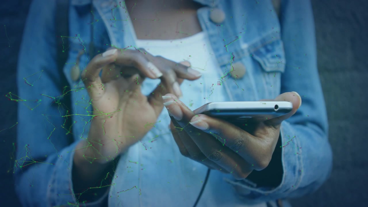 Woman hovering finger above phone screen and tapping while navigating tech app against brick wall