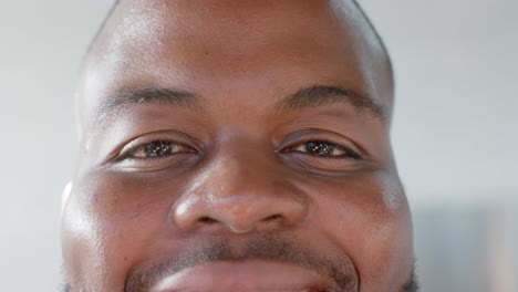 Portrait-close-up-of-happy-african-american-casual-businessman-smiling-in-office,-slow-motion
