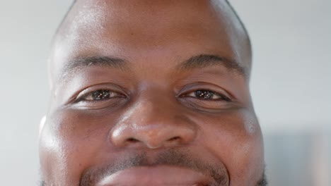 portrait close up of happy african american casual businessman smiling in office, slow motion