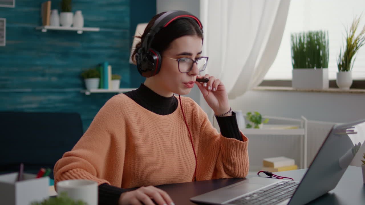 Student talking on online class video call with headphones