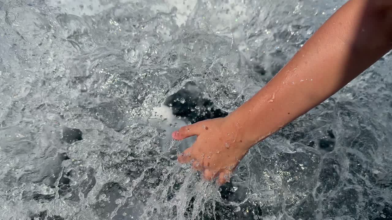Hand touching water