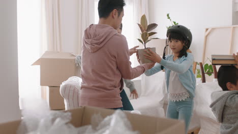 happy-asian-family-moving-into-new-home-owners-with-children-helping-parents-move-into-house-carrying-boxes-enjoying-teamwork-together-with-kids-real-estate-property-investment-4k-footage