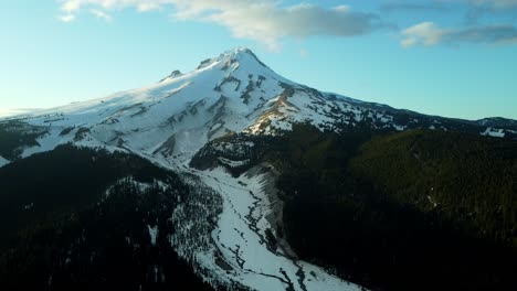 us, oregon, mt hood, white river, 2025-04-22 - drone view of mt hood at sunset over the white river in spring, with snow still covering the mountain and creek and trees