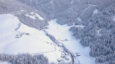 craggy dolomites mountain ridge in mist over snow covered village
