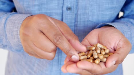 Man holding pills in his hands