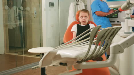 little girl patient waiting pediatric stomatologist woman sitting in dental chair