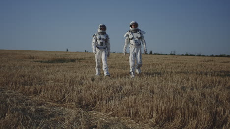 astronauts walking in a field