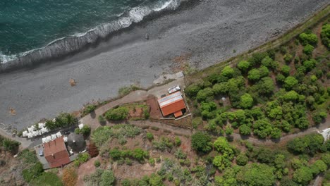 aerial of idyllic faja dos padres with green arable land on volcanic shore