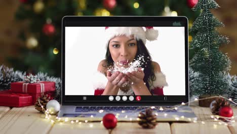 Happy-caucasian-woman-in-santa-costume-on-video-call-on-laptop,-with-christmas-decorations-and-tree