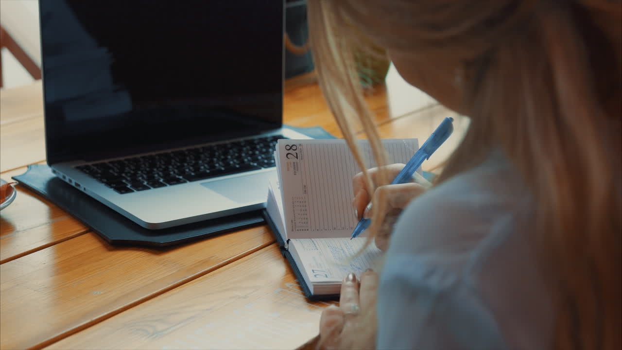 mujer planeando en un café con una computadora portátil
