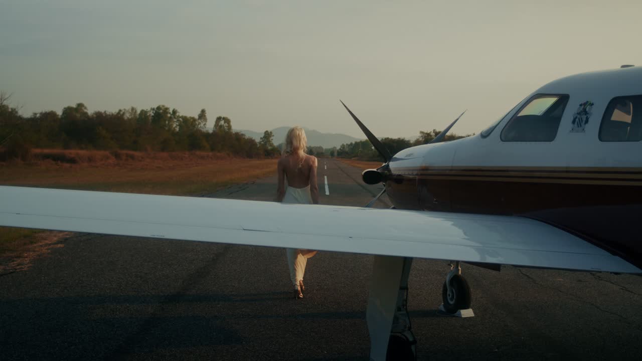 Woman Walking Towards a Private Airplane