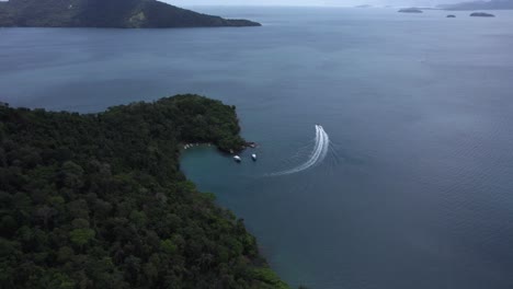 aerial view of a pier and boats on the coast of ilha grande, cloudy day in brazil