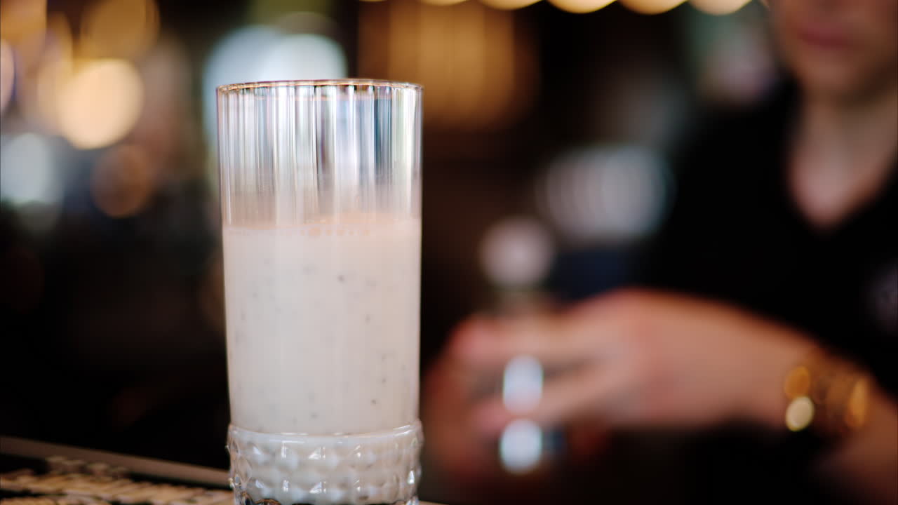Close up of a man pouring a drink in a cocktail