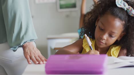 Video-of-african-american-girl-doing-lessons-in-classroom