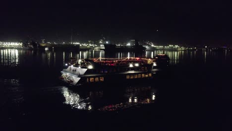 angle or movement 4 (orbit shot): night-time drone shots of a ship cruising misson bay in san diego, california. shot is 4k 60fps and can be slowed down.