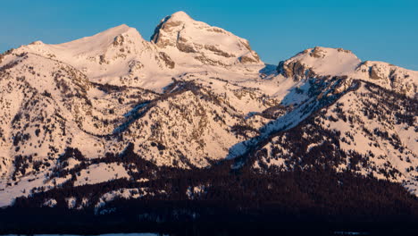 time-lapse of sunrise light sweeping down a mountain face in grand teton national park, wyoming