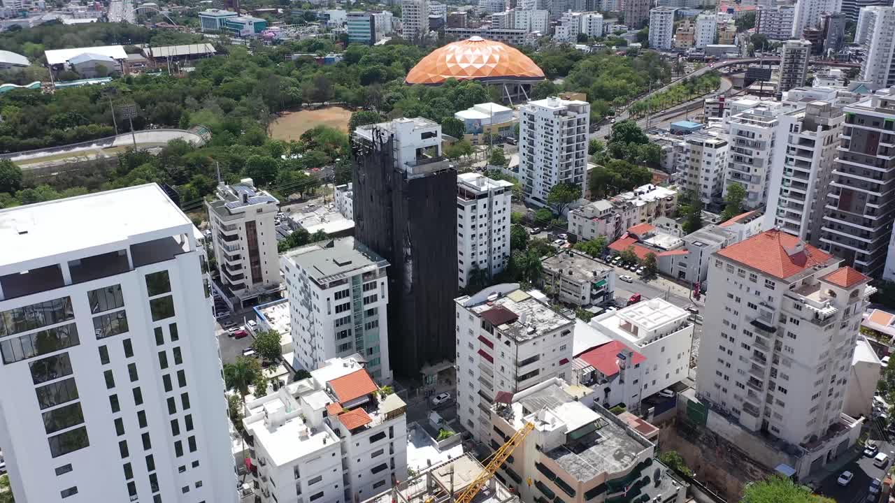 Drone view of the city of Santo Domingo with the Olympic Stadium and beautiful green park in the background