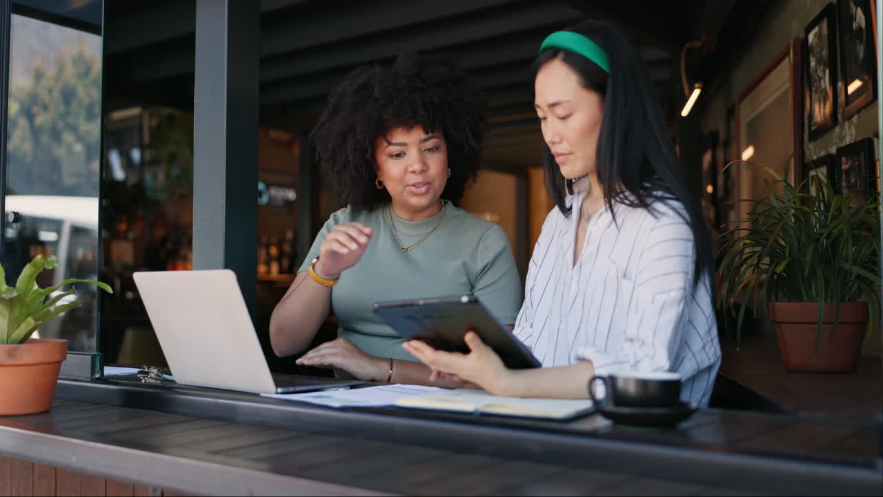 Two Women Collaborating in a Coffee Shop