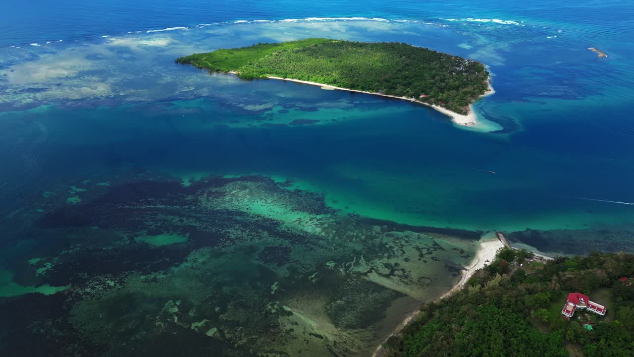Aérea cinematográfica e abrangente da Ilha Magalawa revelando toda a costa, palmeiras e mar turquesa se misturando com areias brancas