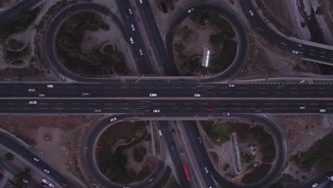 Fast-camera-for-intersection-of-roads,-bridges,-cars,-trucks,-bus,-view-from-the-air-with-drone