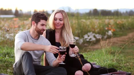 couple having wine in pumpkin filed