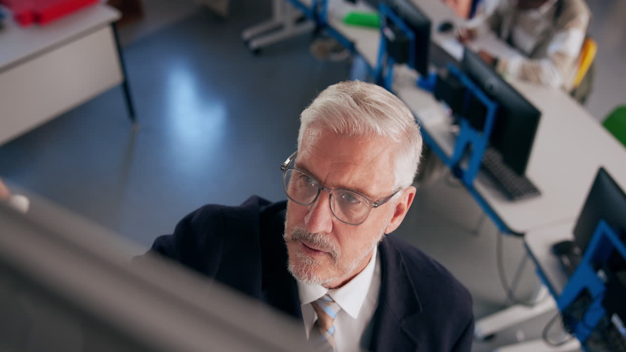 Teacher giving a lecture in a computer classroom