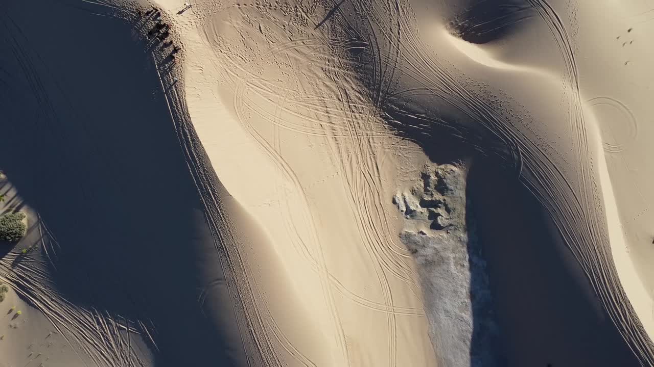 Aerial of the breathtaking Samalayuca Dune Fields south of Ciudad Ju&aacute;rez, Mexico, seen from above with people and vehicles on the ground