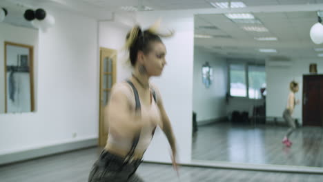 Caucasian-female-dancer-choreographer-performing-freestyle-vogue-dance-in-a-dance-studio