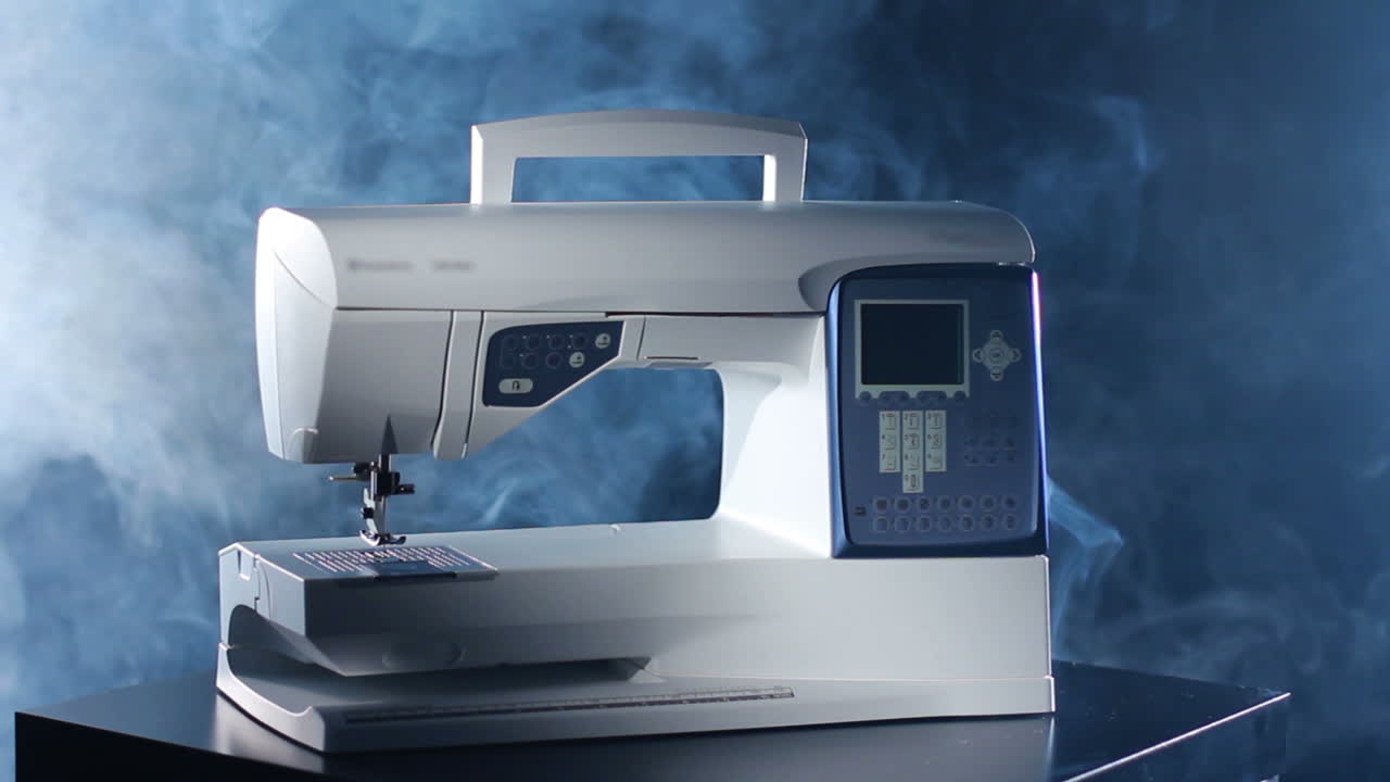 Sewing machine isolated on black background. Modern electric sewing machine