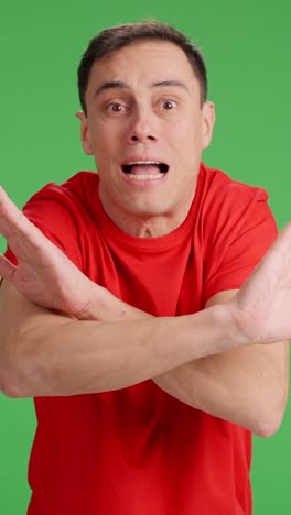 Man arguing with someone looking at camera, green screen background