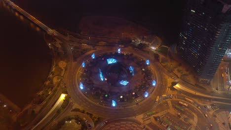 night time illuminated macau city traffic circle bay aerial topdown panorama 4k china