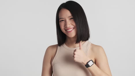 asian woman showing ok gesture on camera.