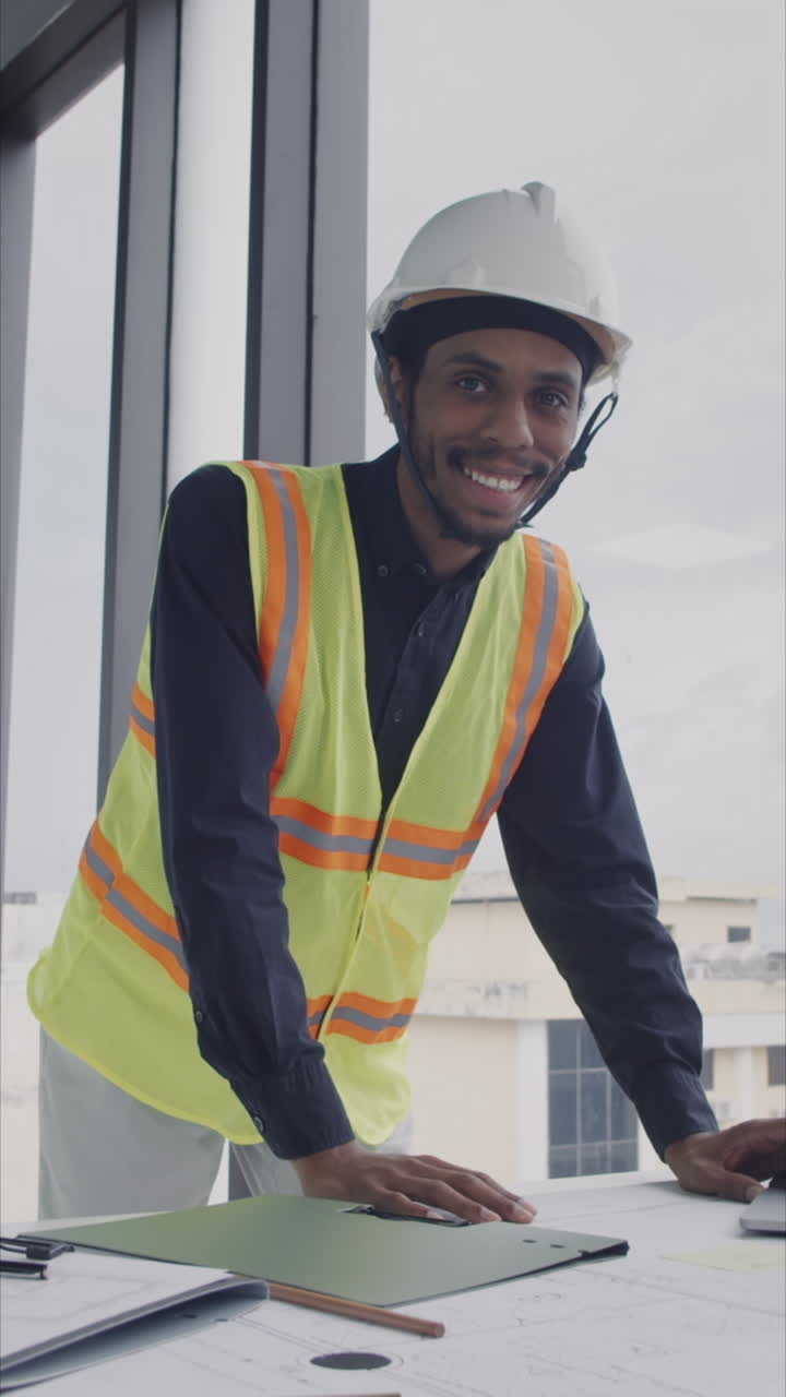 Vertical Portrait of Black Architect near Table with Blueprints