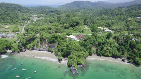 Amazing-descending-drone-view-of-a-naturally-formed-cave-on-the-coastline-of-an-amazing-beach-on-the-Caribbean-islands-of-Trinidad-and-Tobago