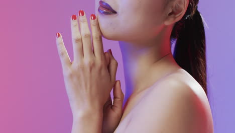 asian woman with black hair and make up touching her chin, copy space, slow motion