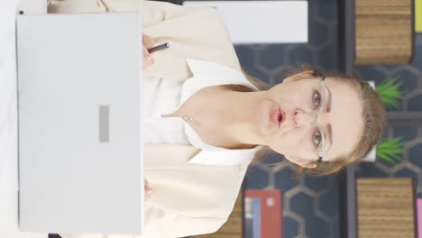 Vertical-video-of-Angry-talking-business-woman-looking-at-camera.