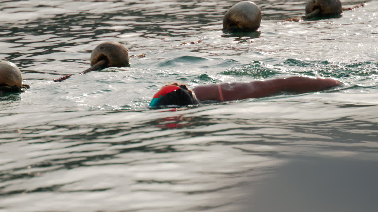 Cannes, France - October 9, 2025: A woman snorkeling in the ocean, floating in gentle water under soft sunlight