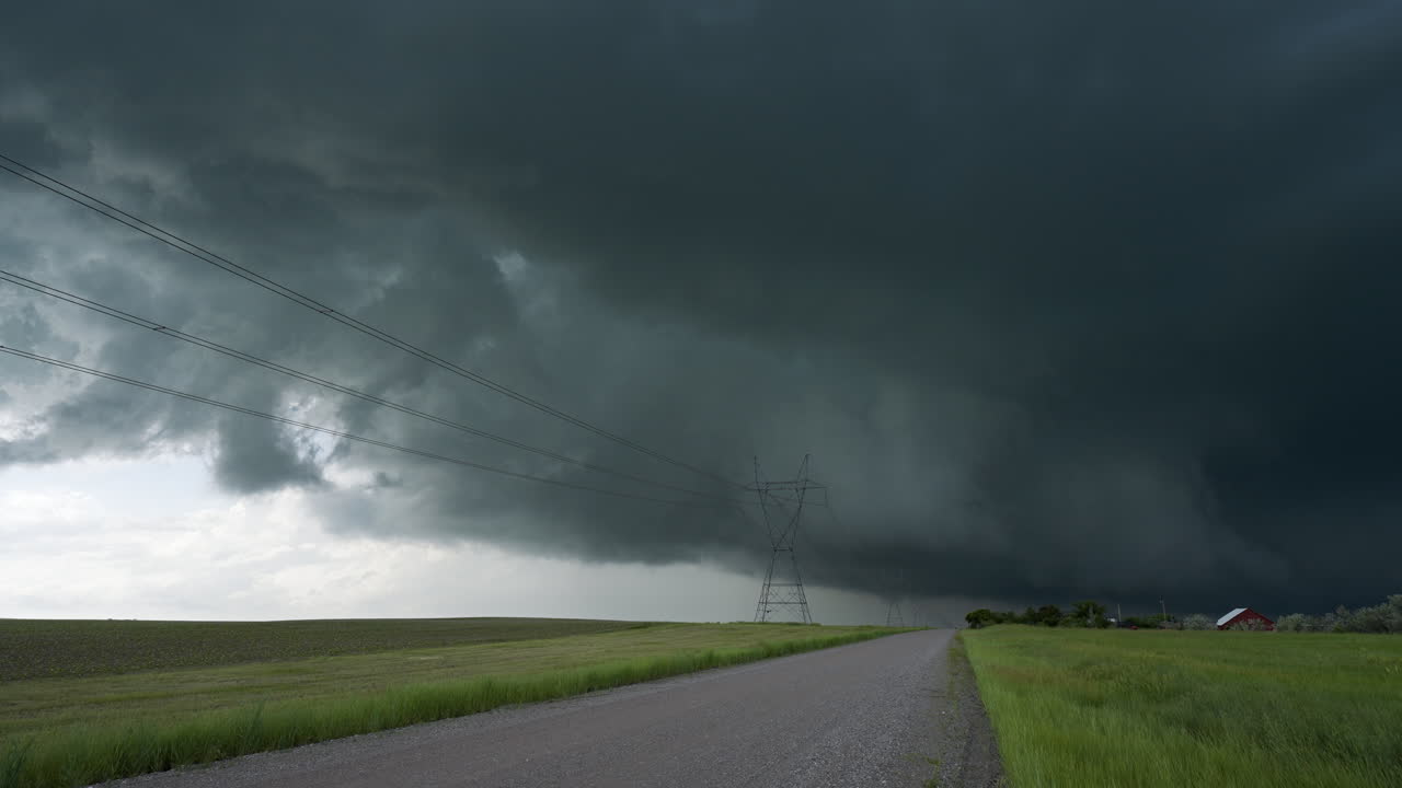 Black Storm Clouds Loom Over Quiet Road Leading Away