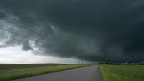 black storm clouds loom over quiet road leading away