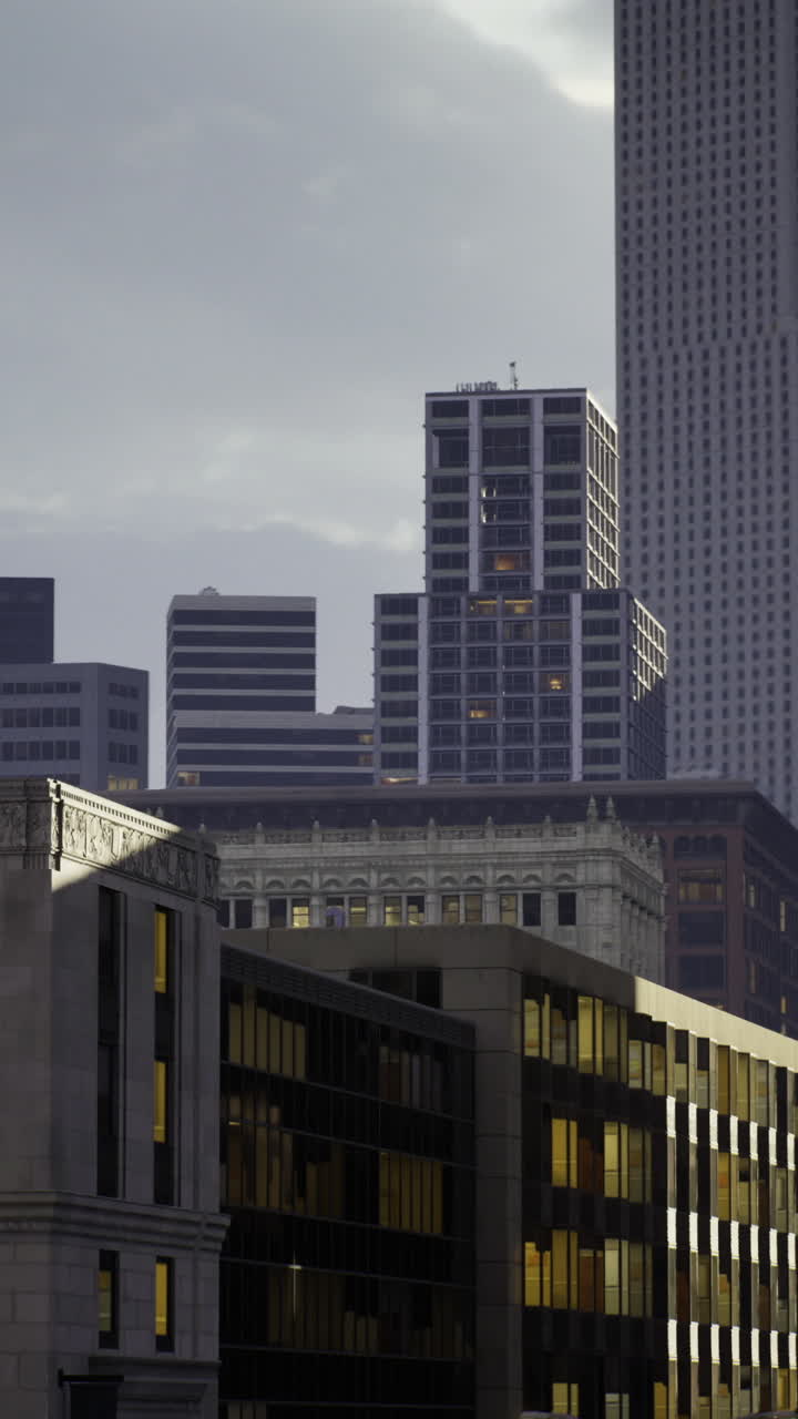 Urban skyline at dusk featuring modern architecture and historical elements