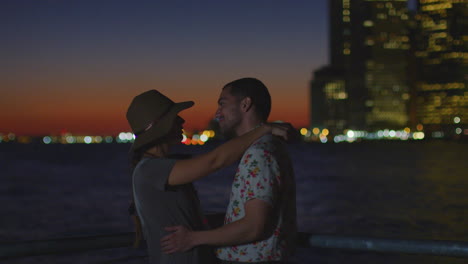 romantic couple with manhattan skyline at dusk in background