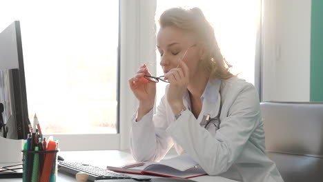 tired female doctor having headache at work