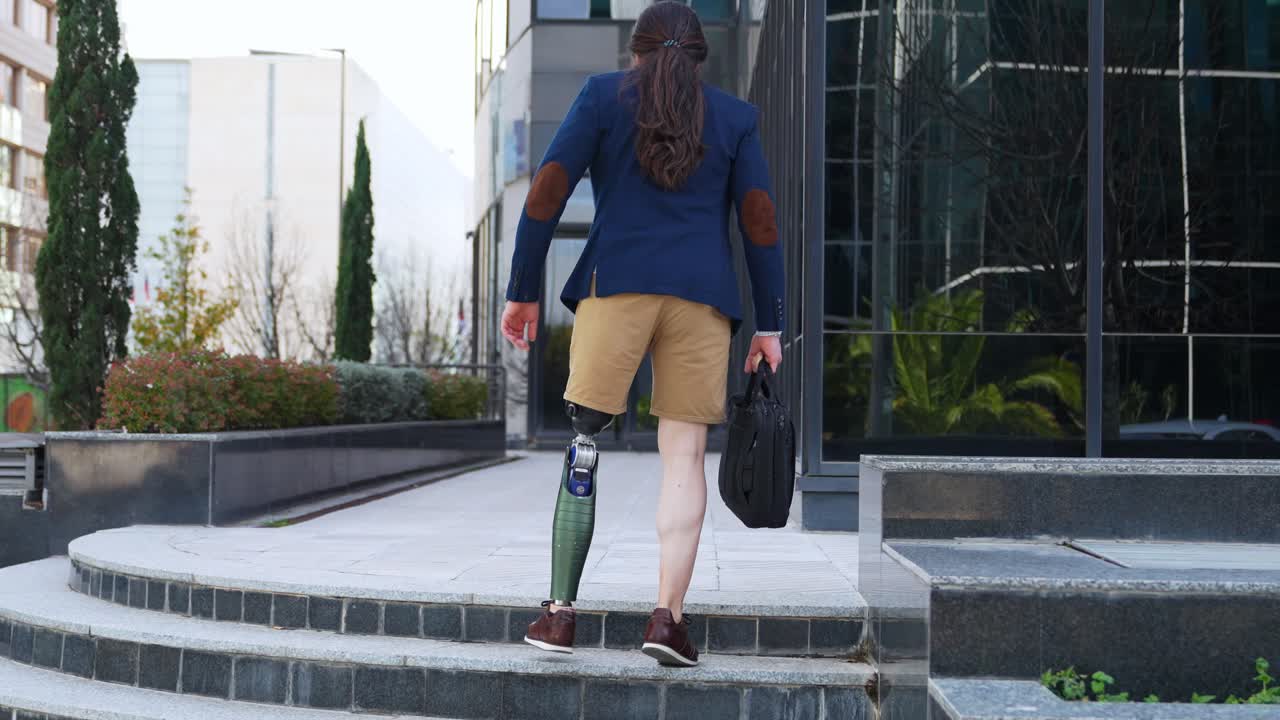 Man with prosthetic leg walking up stairs
